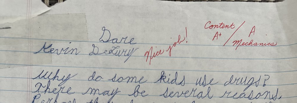 Handwritten D.A.R.E. essay by Kevin DeLury, graded Content A-plus, Mechanics A, with Nice job written in red