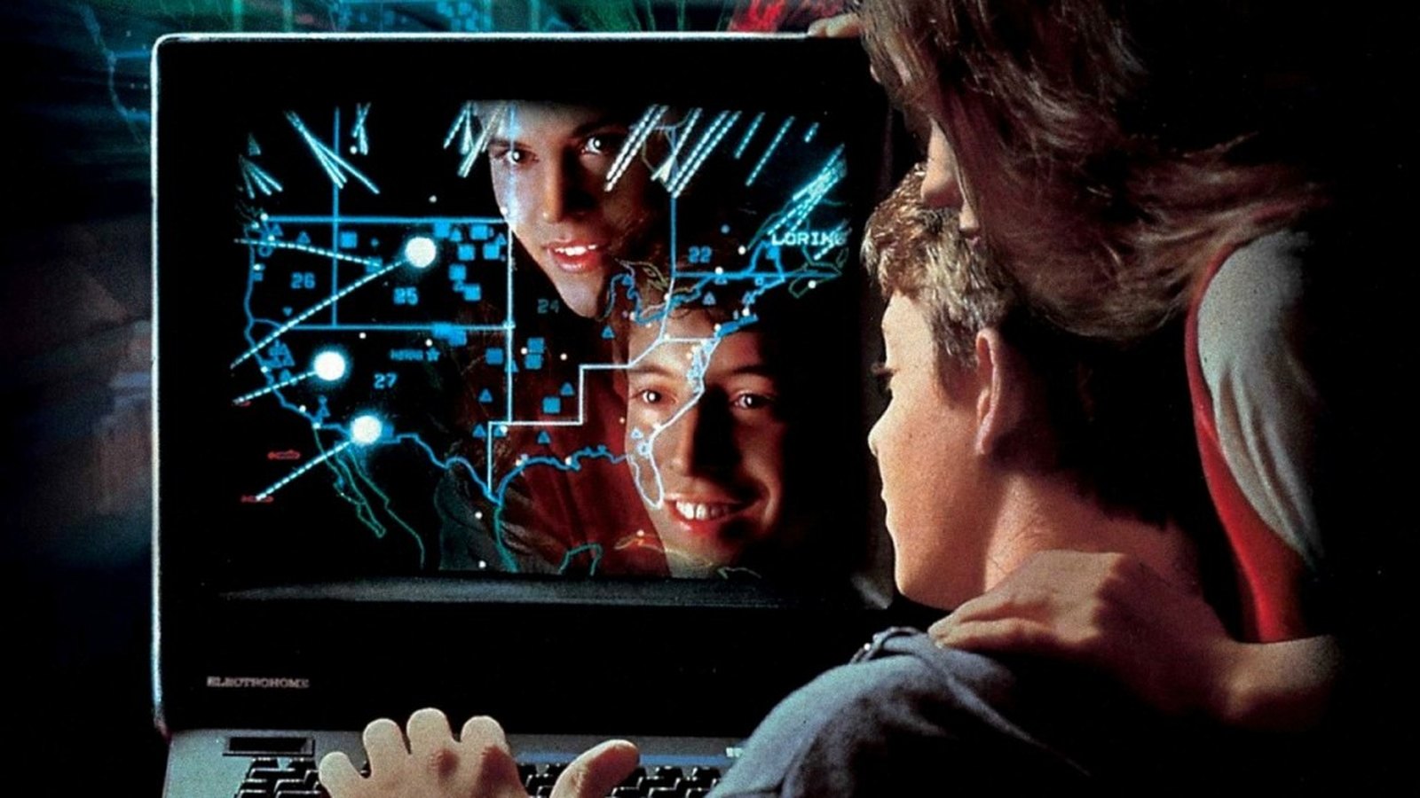 Two teenagers watching a computer display in the 1983 film WarGames