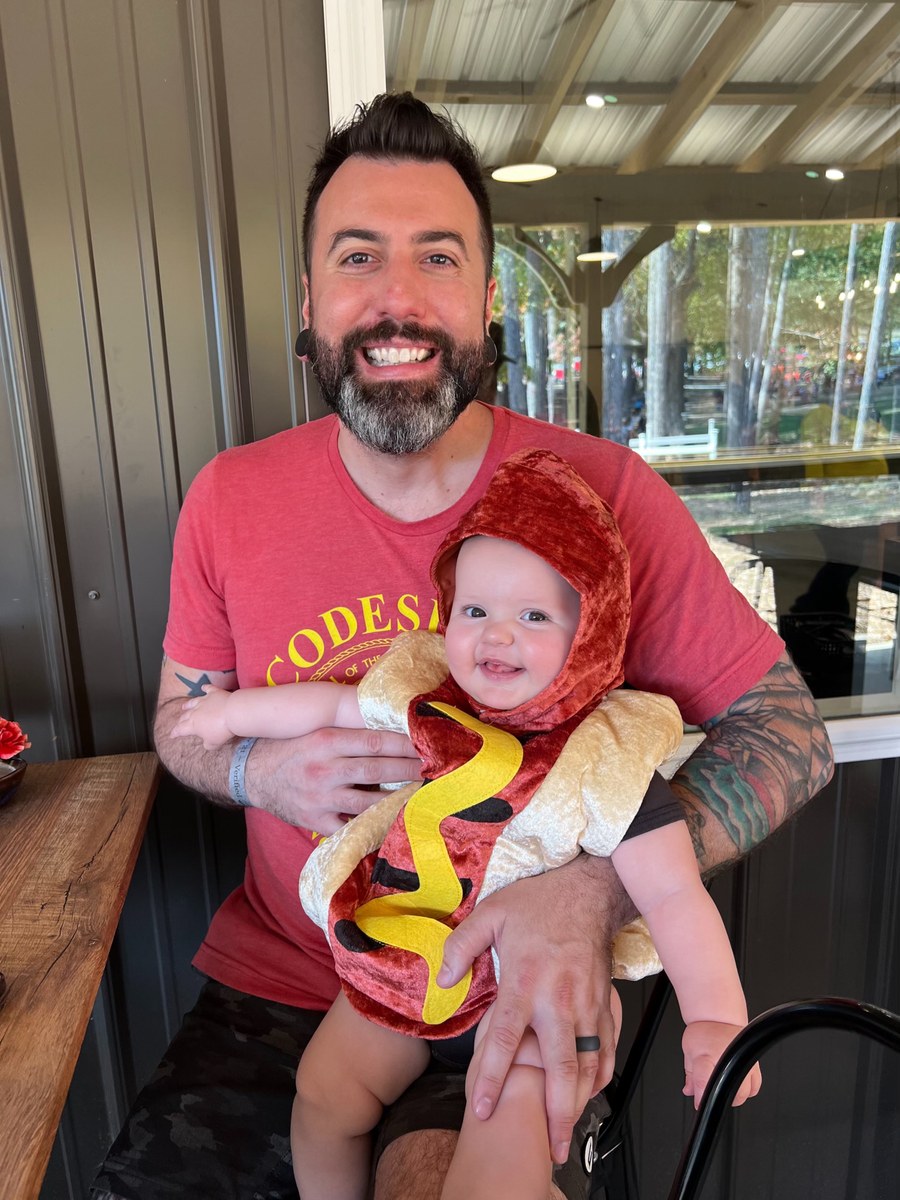Kevin DeLury with his son in a hot-dog Halloween costume